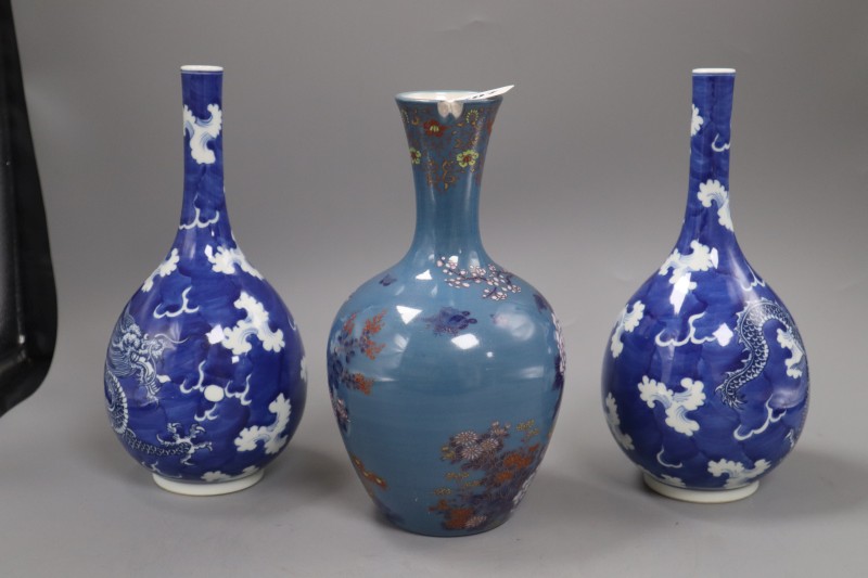 A pair of Chinese blue and white dragon bottle vases and a Fukagawa enamelled blue ground vase, tallest 25cm